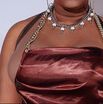 Woman wearing a satin dress against a plain background